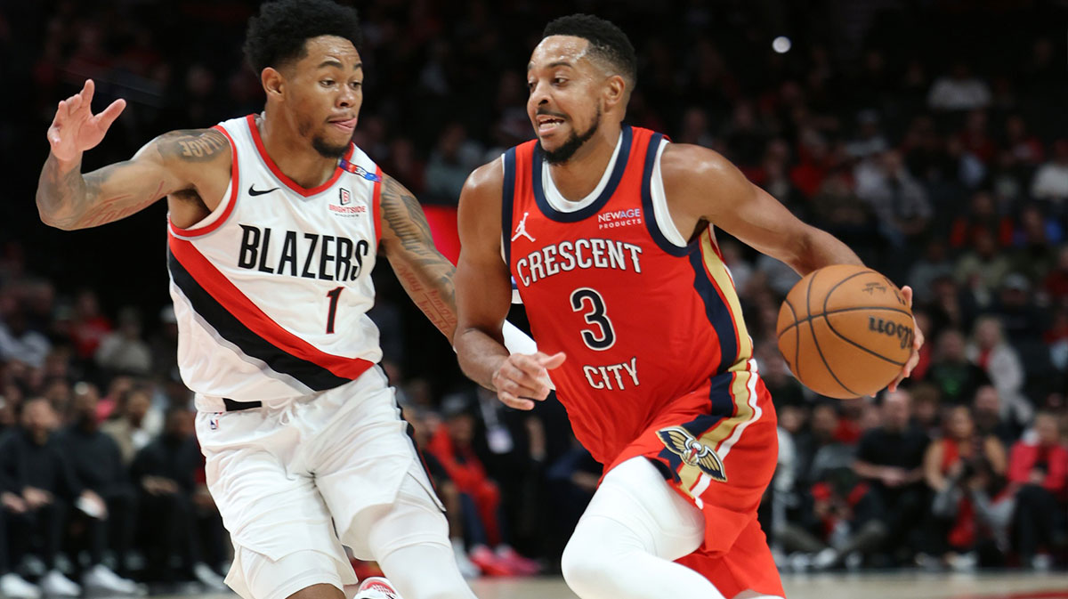 New Orleans Pelicans guard CJ McCollum (3) drives on Portland Trail Blazers guard Anfernee Simons (1) in the first half at Moda Center.