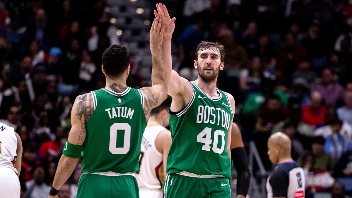 Celtics center Luke Kornet (40) slaps hands with forward Jayson Tatum (0) after dunking the ball against the New Orleans Pelicans during the second half at Smoothie King Center