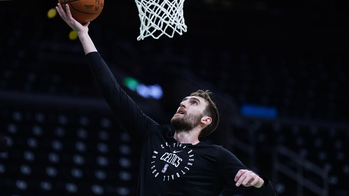 Celtics center Luke Kornet (40) warms up before game five of first round for the 2025 NBA Playoffs against the Orlando Magic at TD Garden with the Clippers logo in the background and the Spurs logo in the background