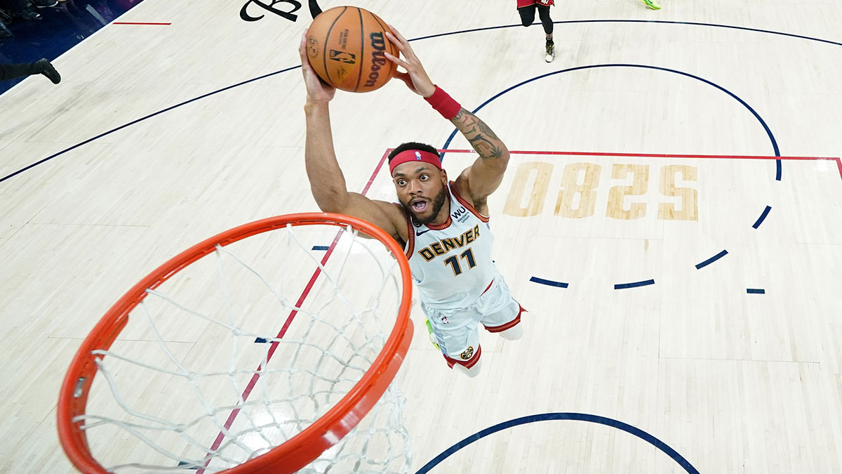 Denver Nuggets forward Bruce Brown (11) dunks against the Miami Heat during the first half in game five of the 2023 NBA Finals at Ball Arena.