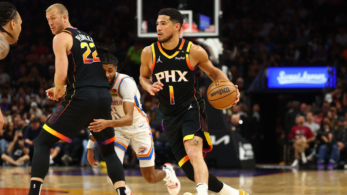 Phoenix Suns guard Devin Booker (1) dribbles the ball against the Oklahoma City Thunder during the first half at Footprint Center.