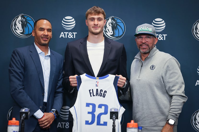 Dallas Mavericks first overall pick Cooper Flagg (center), poses with his jersey with...