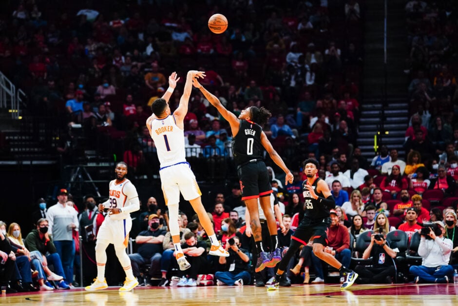 Devin Booker #1 of the Phoenix Suns shoots over Jalen Green #0 of the Houston Rockets during the game at Toyota Center on November 14, 2021 in Houston, Texas.