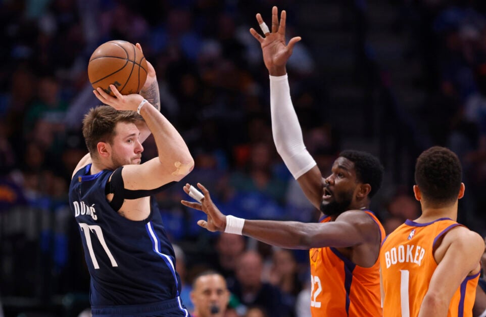 LA Lakers stars Luka Doncic #77 of the Dallas Mavericks looks to pass around Deandre Ayton #22 of the Phoenix Suns during the first half of Game Four of the 2022 NBA Playoffs Western Conference Semifinals at American Airlines Center on May 8, 2022 in Dallas, Texas.