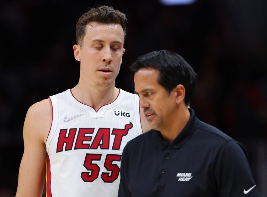 Miami Heat forward Duncan Robinson confers with head coach Erik Spoelstra