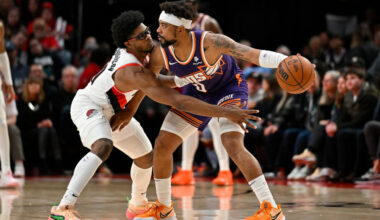 Scoot Henderson #00 of the Portland Trail Blazers and Jordan Goodwin #0 of the Phoenix Suns in acti...