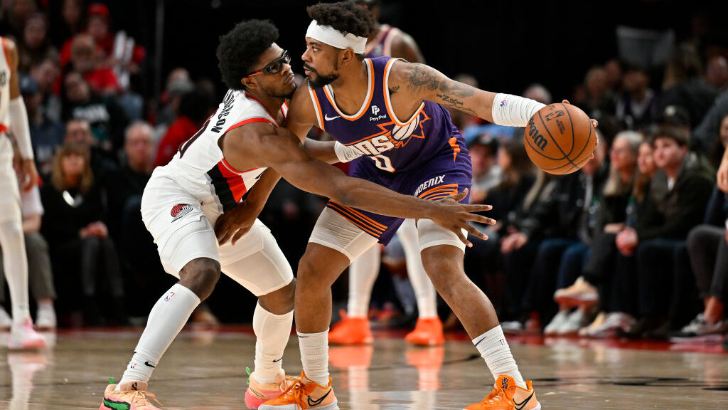 Scoot Henderson #00 of the Portland Trail Blazers and Jordan Goodwin #0 of the Phoenix Suns in acti...