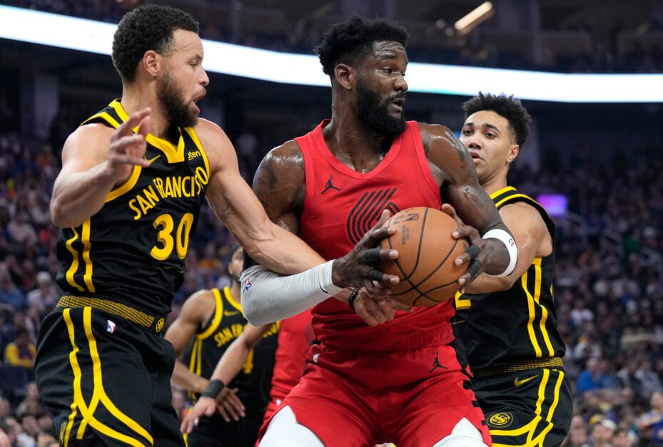 Portland Trail Blazers center Deandre Ayton is defended by Golden State Warriors guard Stephen Curry