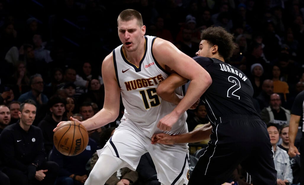 Cameron Johnson defending Denver Nuggets' Nikola Jokic