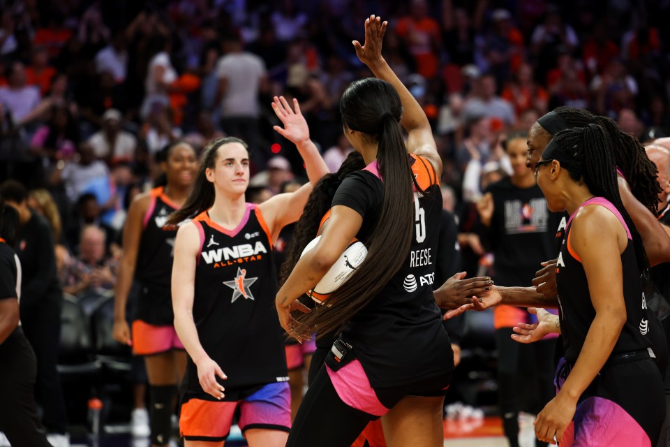 PHOENIX, AZ - JULY 20: Caitlin Clark #22 and Angel Reese #5 of Team WNBA high five during the 2024 WNBA All Star Game at Footprint Center on July 20, 2024 in Phoenix, Arizona. NOTE TO USER: User expressly acknowledges and agrees that, by downloading and/or using this Photograph, user is consenting to the terms and conditions of the Getty Images License Agreement. Mandatory Copyright Notice: Copyright 2024 NBAE (Photo by Dylan Goodman/NBAE via Getty Images)
