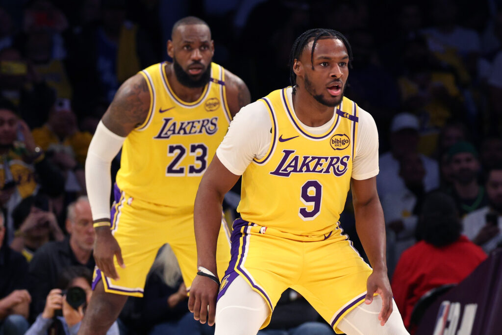 LeBron James #23 and Bronny James #9 of the Los Angeles Lakers on defence