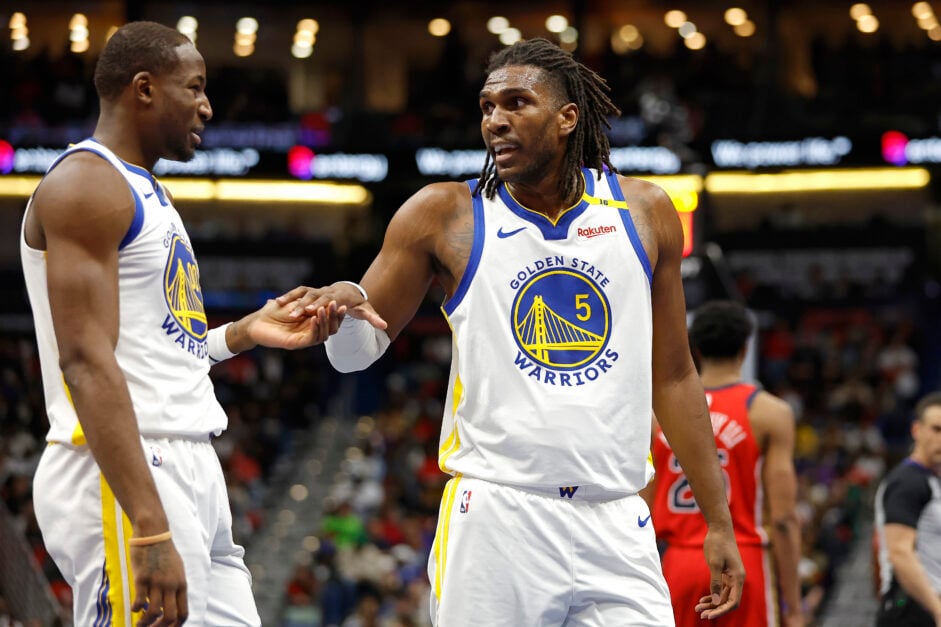 Kevon Looney gestures while speaking to Warriors teammate Jonathan Kuminga
