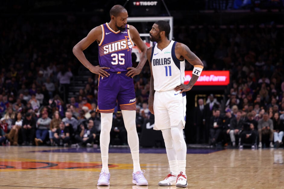 Kevin Durant #35 of the Phoenix Suns talks with Kyrie Irving #11 of the Dallas Mavericks during the second half at Footprint Center on December 27, 2024 in Phoenix, Arizona.
