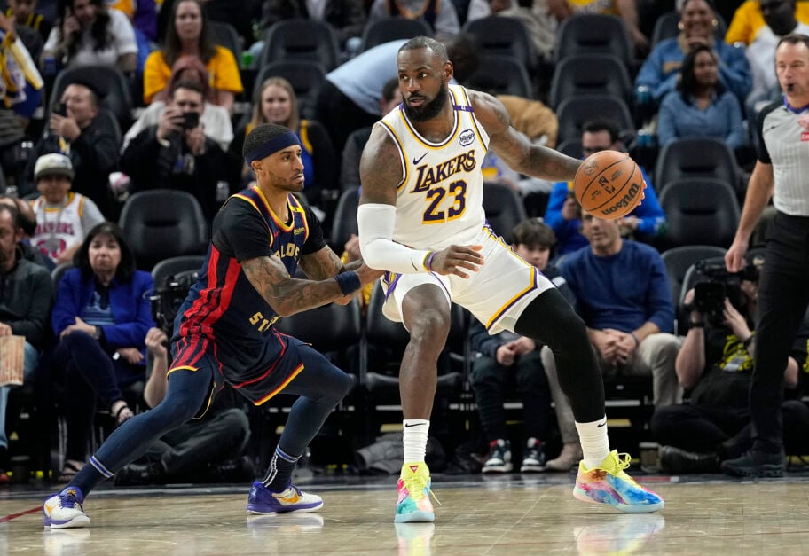 LeBron James #23 of the Los Angeles Lakers dribbling the ball is guarded by Gary Payton II #0 of the Golden State Warriors during the second half of an NBA basketball game at Chase Center