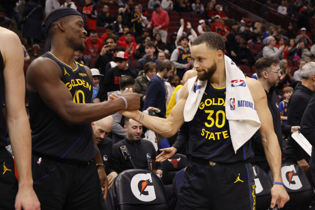 Jimmy Butler #10 and Stephen Curry #30 of the Golden State Warriors celebrate after the game against the Chicago Bulls