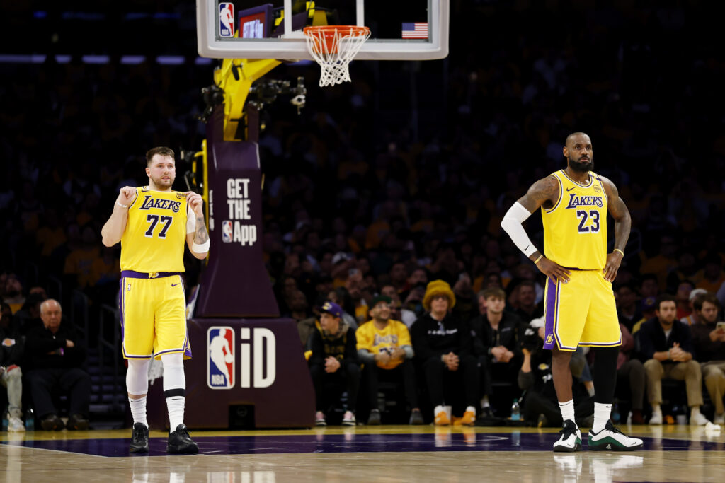 Luka Doncic #77 and LeBron James #23 of the Los Angeles Lakers look on