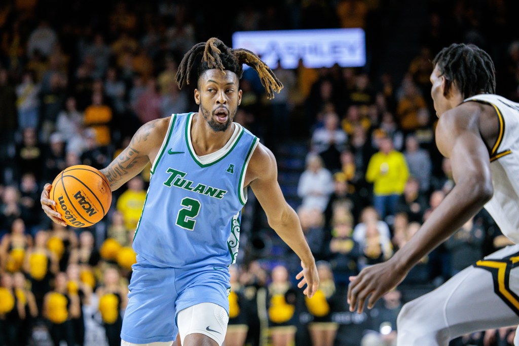 Tulane basketball player dribbling the ball.