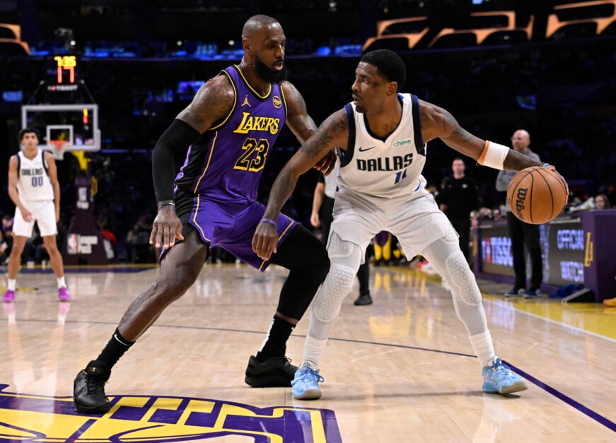 Kyrie Irving #11 of the Dallas Mavericks controls the ball against LeBron James #23 of the Los Angeles Lakers in the first half of a NBA basketball game at Crypto.com Arena.