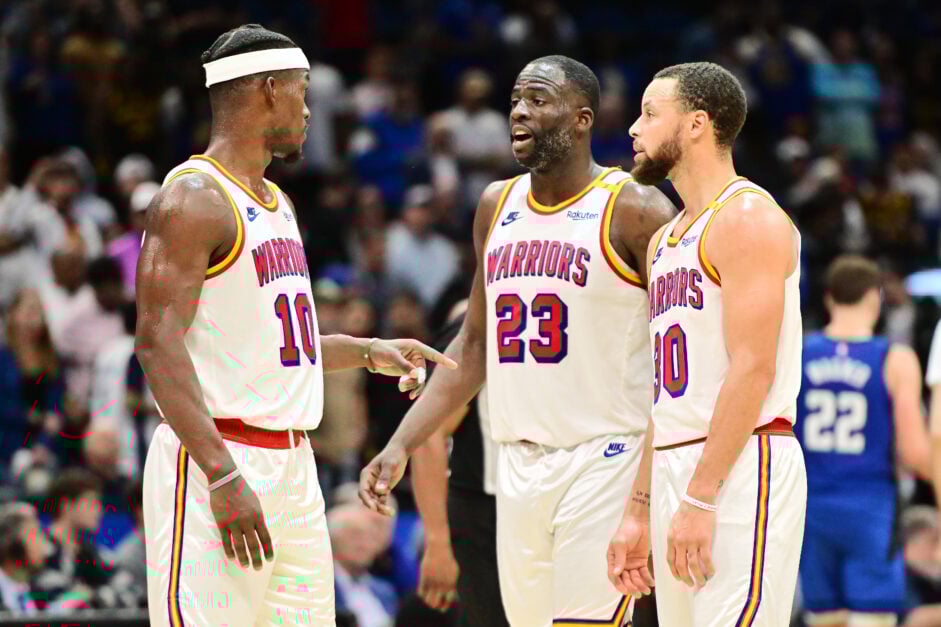 Jimmy Butler III #10, Draymond Green #23 and Stephen Curry #30 of the Golden State Warriors react in the second half against the Orlando Magic at Kia Center on February 27, 2025 in Orlando, Florida.