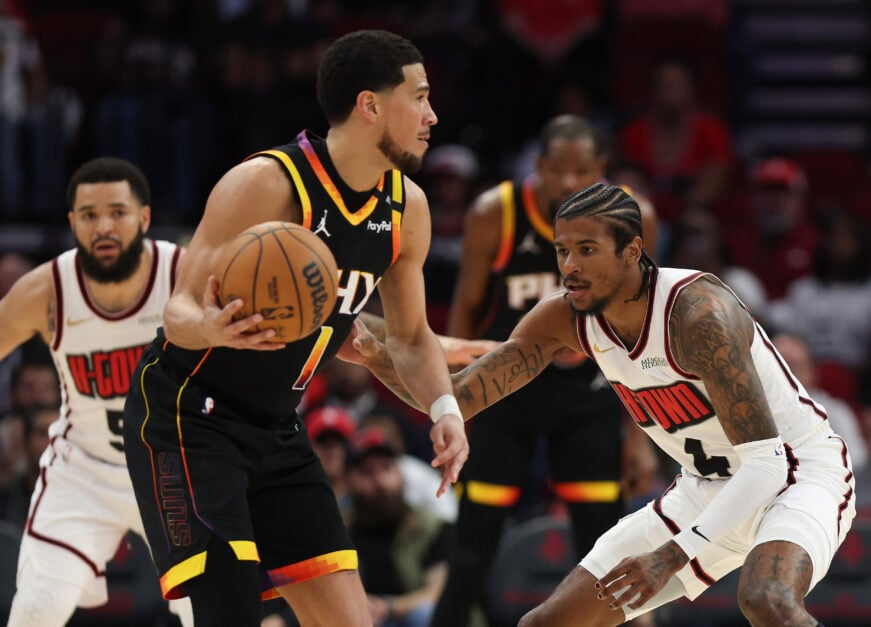 Jalen Green #4 of the Houston Rockets defends against Devin Booker #1 of the Phoenix Suns during the first half of the game at Toyota Center on March 12, 2025