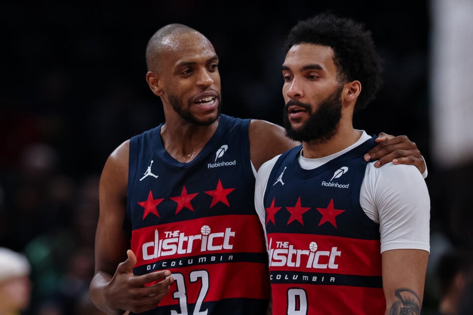 Khris Middleton talking to teammate Justin Champagnie during a game