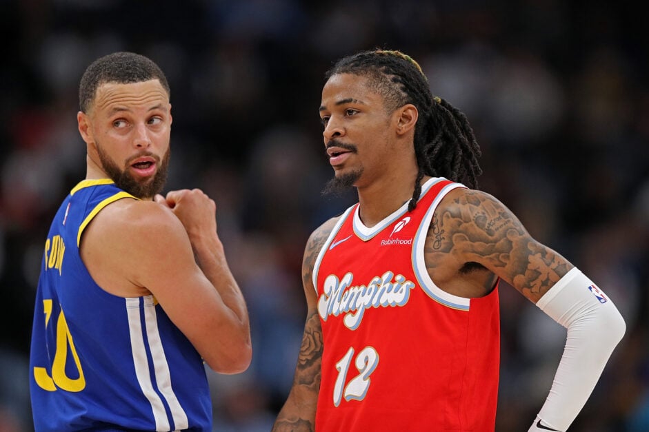 Ja Morant #12 of the Memphis Grizzlies looks on at Stephen Curry #30 of the Golden State Warriors during the first half at FedExForum on April 01, 2025 in Memphis, Tennessee.