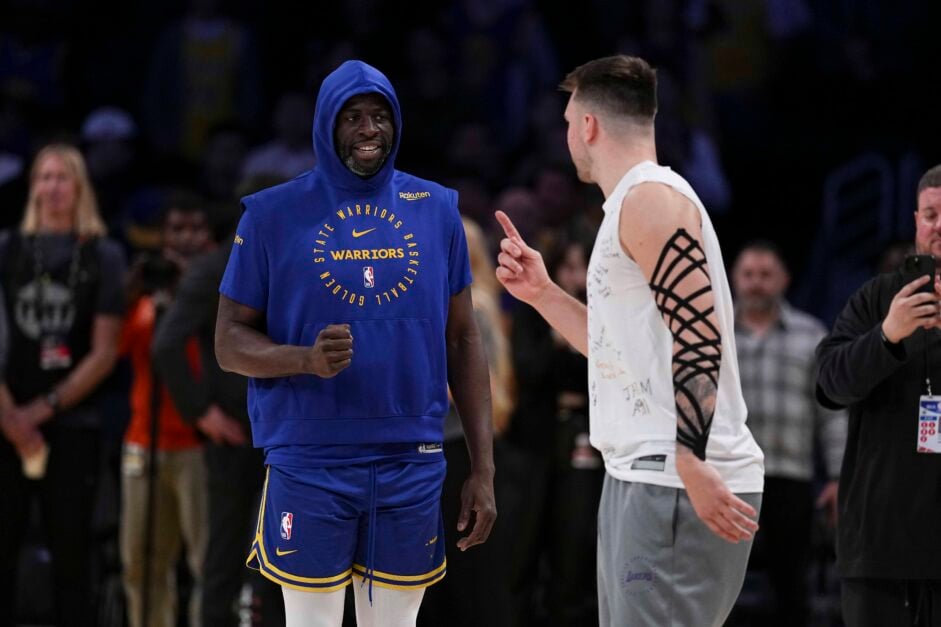 Golden State Warriors forward Draymond Green confers with Los Angeles Lakers guard Luka Doncic