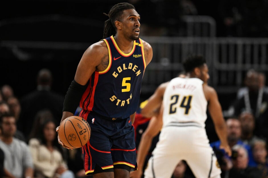 Kevon Looney holds the ball with one hand during Warriors game
