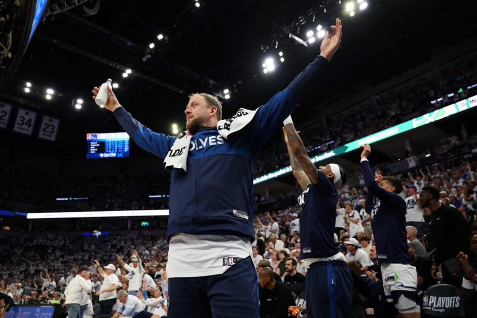 Joe Ingles in Timberwolves tracksuit with arms outstretched