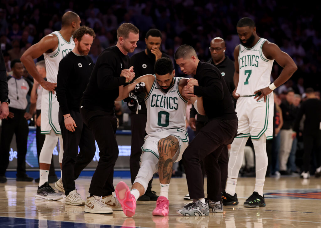 Jayson Tatum #0 of the Boston Celtics is assisted off the court after an injury