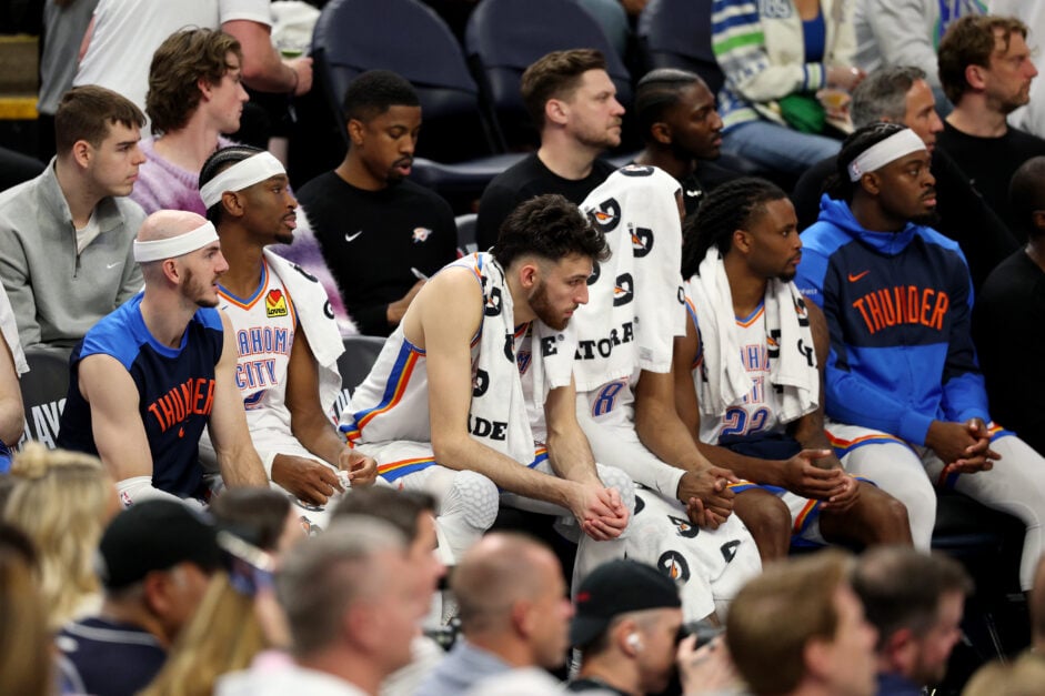 Alex Caruso, Shai Gilgeous-Alexander, Chet Holmgren, Jalen Williams, Cason Wallace, and Isaiah Joe sit on the OKC Thunder bench