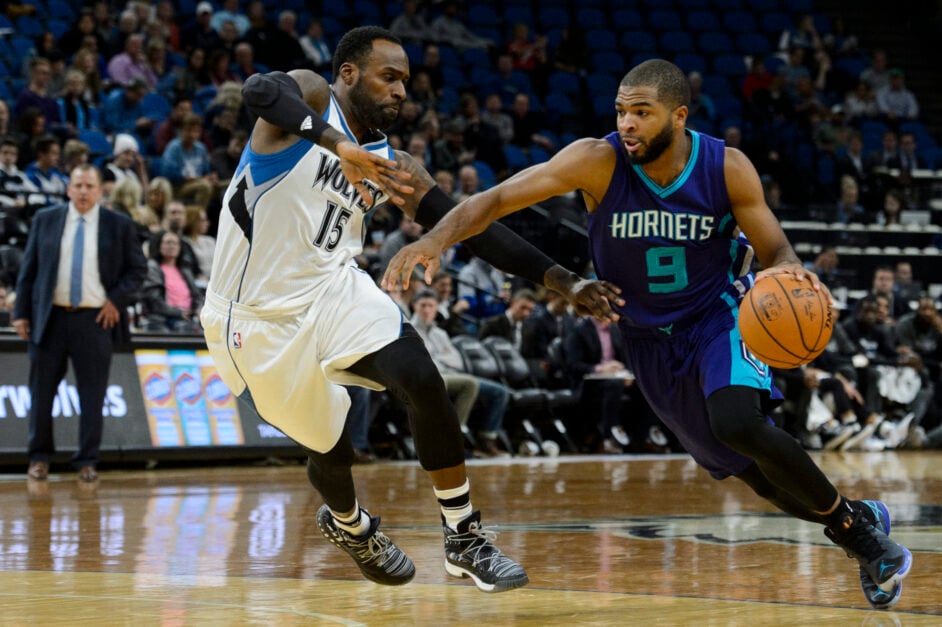 Charlotte Hornets guard Aaron Harrison dribbles against Minnesota Timberwolves guard Shabazz Muhammad