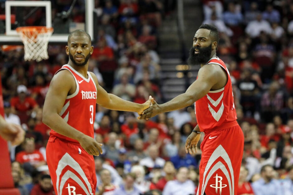 Chris Paul #3 of the Houston Rockets congratulates James Harden #13 after a three point shot in the first half against the Washington Wizards.