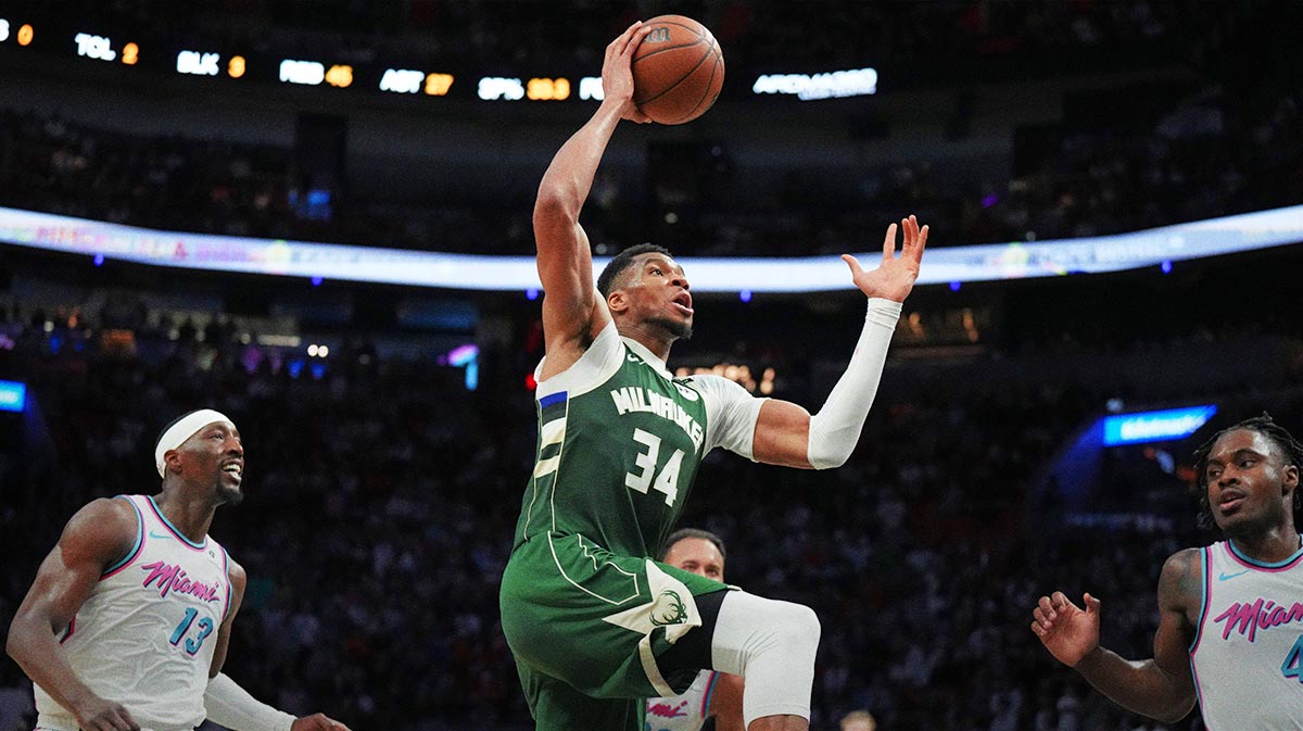 Milwaukee Bucks forward Giannis Antetokounmpo (34) goes up for a dunk in overtime as Miami Heat center Bam Adebayo (13) follows on the play at Kaseya Center.