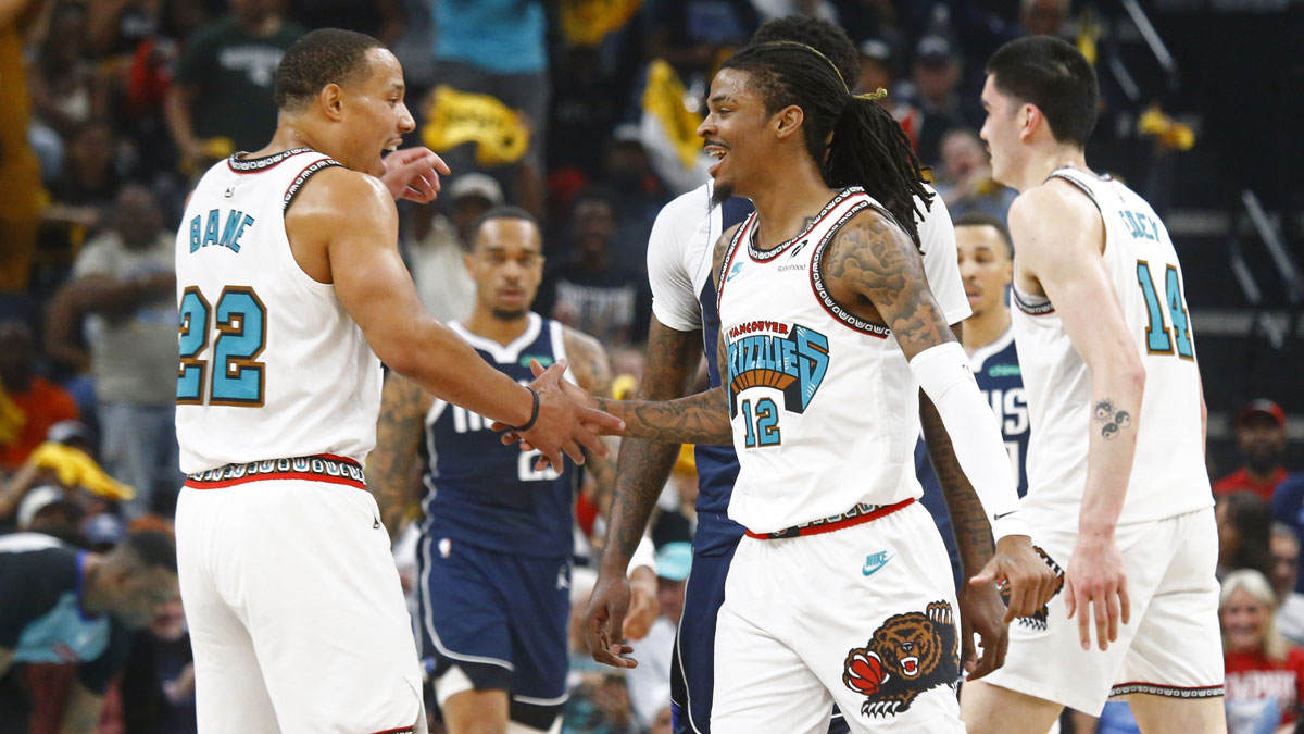 Grizzlies guard Ja Morant (12) reacts with guard Desmond Bane (22) during the first quarter against the Dallas Mavericks at FedExForum