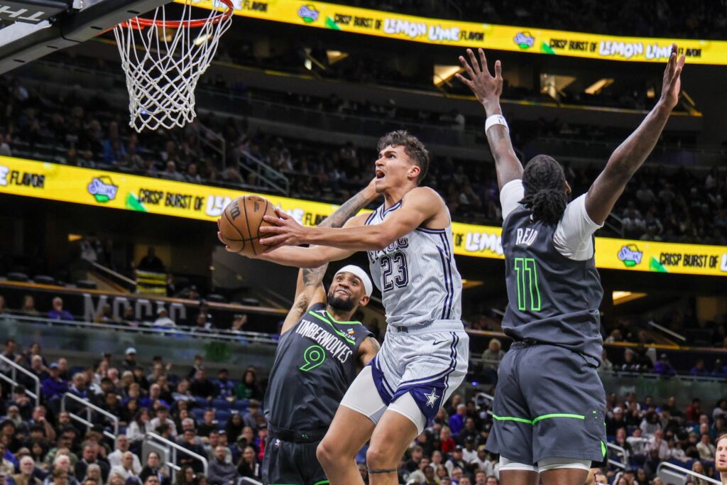 Orlando Magic forward Tristan da Silva (23) is fouled by Minnesota Timberwolves guard Nickeil Alexander-Walker (9)