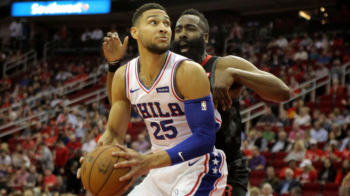 Philadelphia 76ers guard-forward Ben Simmons (25) handles the ball while Houston Rockets guard James Harden (13) defends during the first quarter at Toyota Center.
