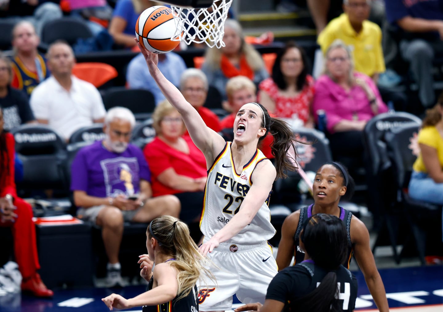 Fever guard Caitlin Clark drove to the basket during her third- (22) drives to the basket during the third quarter at TD Garden.