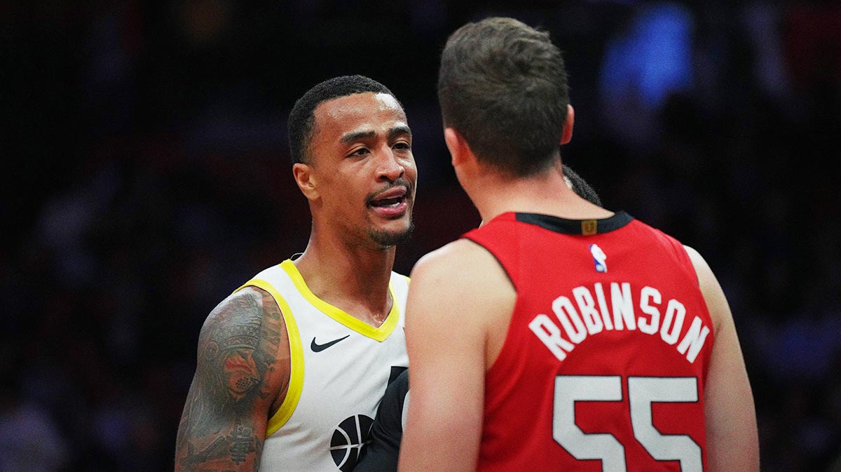 Utah Jazz forward John Collins (20) gets into a discussion with Miami Heat forward Duncan Robinson (55) after being called for a technical foul earlier during the second half at Kaseya Center.