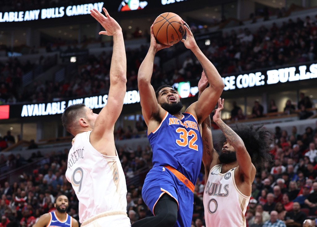 Karl-Anthony Towns (left) Karl-Anthony shoots over Nikola Vucevic during the Knicks' 139-126 loss to the Bulls on Jan. 4, 2025.