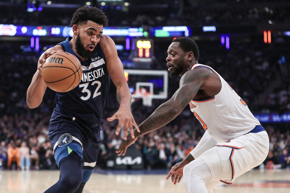 Minnesota Timberwolves center Karl-Anthony Towns (32) looks to drive past New York Knicks forward Julius Randle (30) in the first quarter at Madison Square Garden. 
