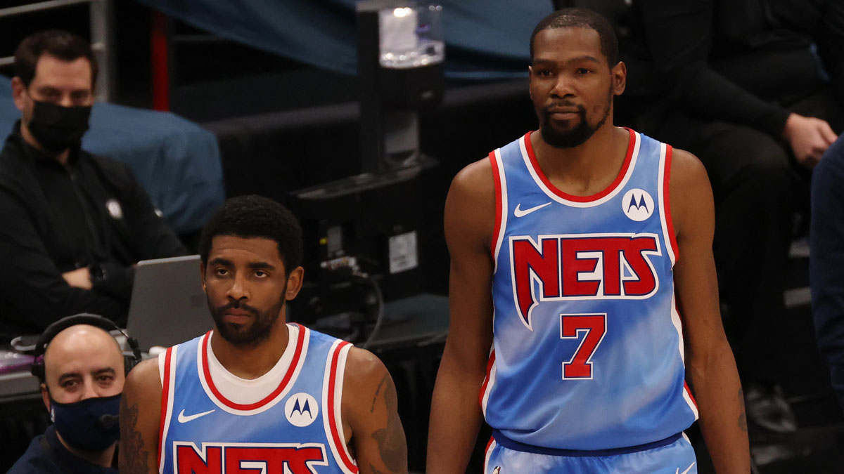 Brooklyn Nets guard Kyrie Irving (11) and Nets forward Kevin Durant (7) stand at the scorer's table against the Washington Wizards at Capital One Arena. 