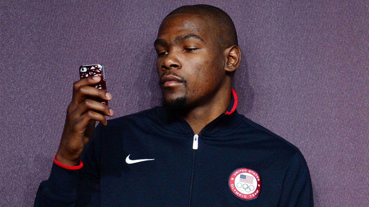 USA guard Kevin Durant (5) checks his phone during a press conference in preparation for the 2012 London Olympic Games at the Main Press Center.  