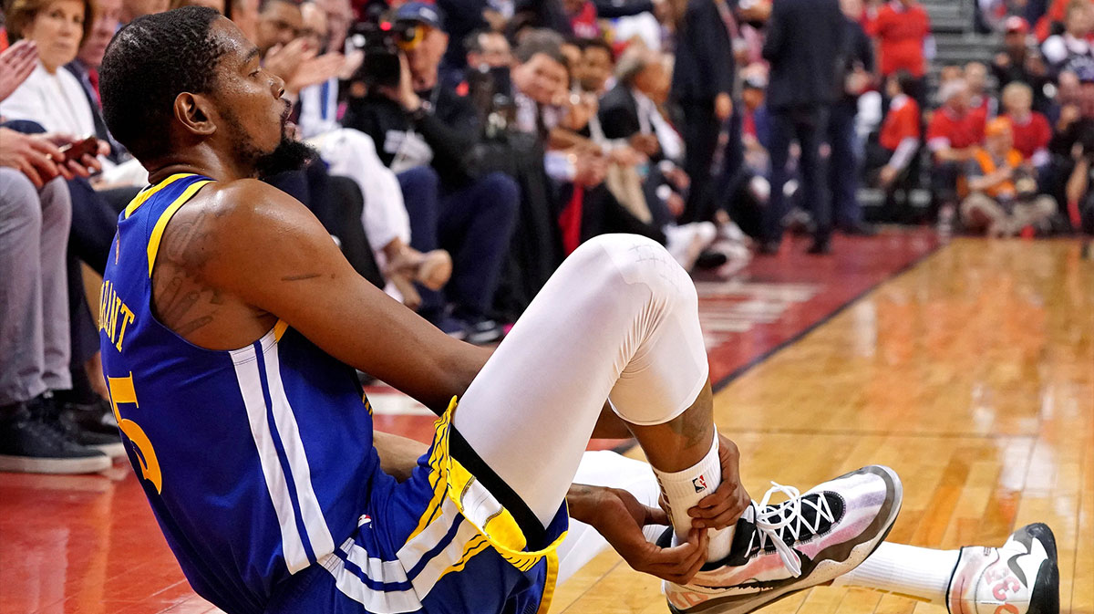 Golden State Warriors forward Kevin Durant (35) sits on the court after an apparent injury during the second quarter in game five against the Toronto Raptors of the 2019 NBA Finals at Scotiabank Arena.