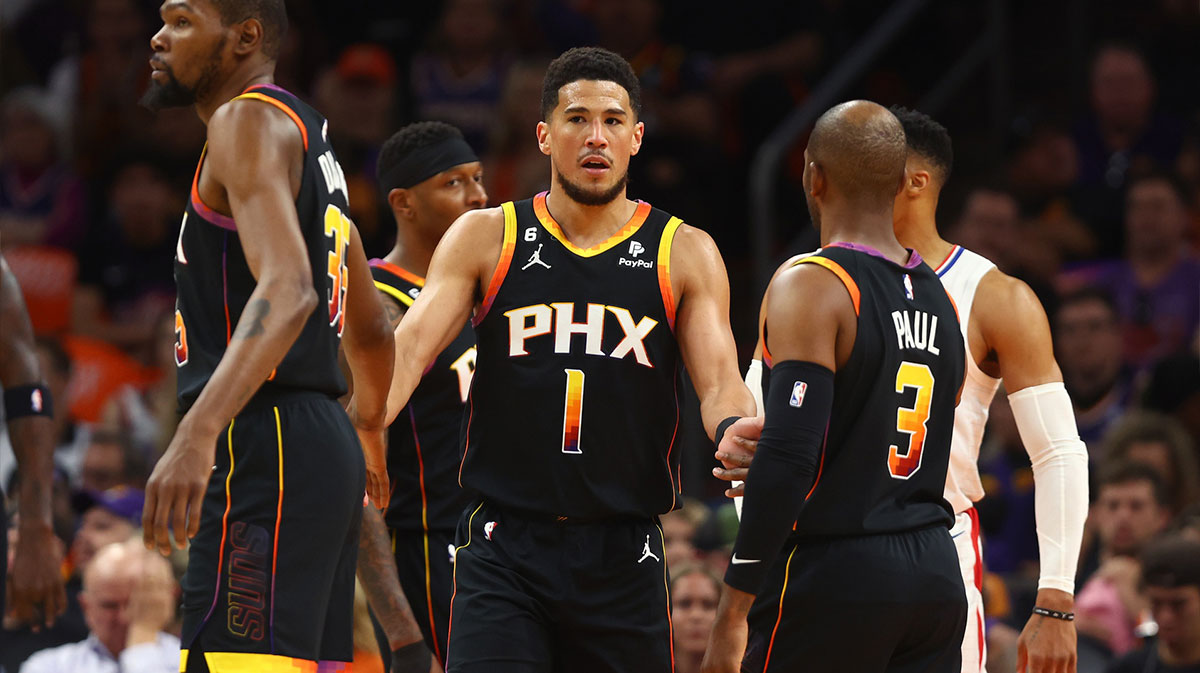 Phoenix Suns guards Devin Booker (1) celebrates with forward Kevin Durant (35) and guard Chris Paul (3) against the Los Angeles Clippers during the first half in game five of the 2023 NBA playoffs at Footprint Center.