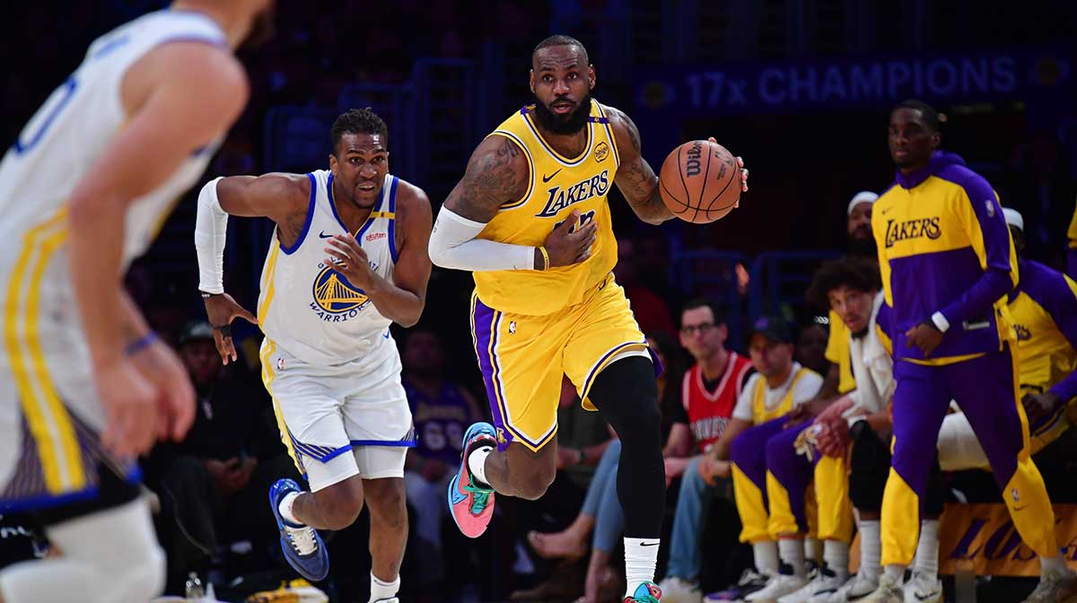 Los Angeles Lakers forward LeBron James (23) moves the ball up court ahead of Golden State Warriors forward Kevon Looney (5) during the first half at Crypto.com Arena.