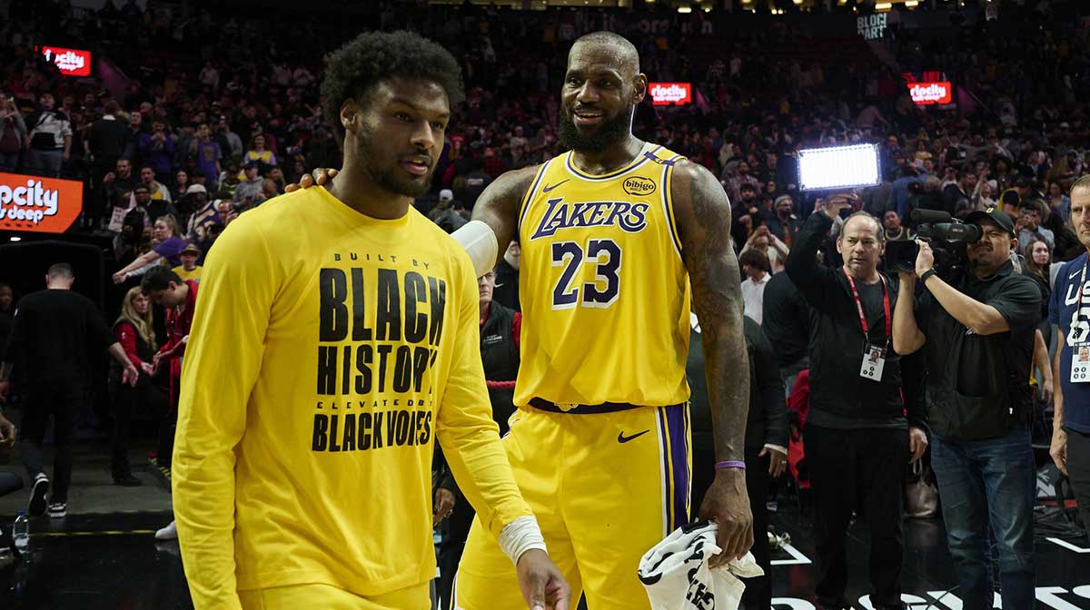 Los Angeles Lakers forward LeBron James (23) celebrates victory over the Portland Trail Blazers with his son guard Bronny James (9) at Moda Center.