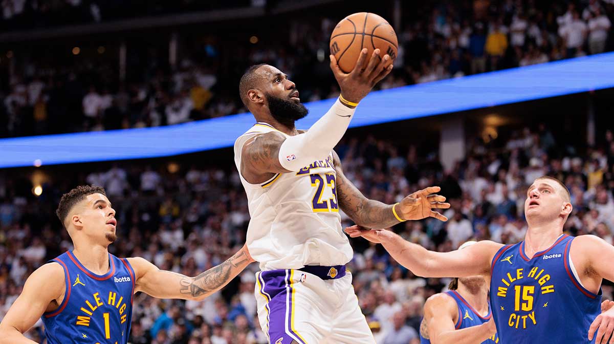 Los Angeles Lakers forward LeBron James (23) shoots the ball against Denver Nuggets center Nikola Jokic (15) during the fourth quarter in game one of the first round for the 2024 NBA playoffs at Ball Arena.