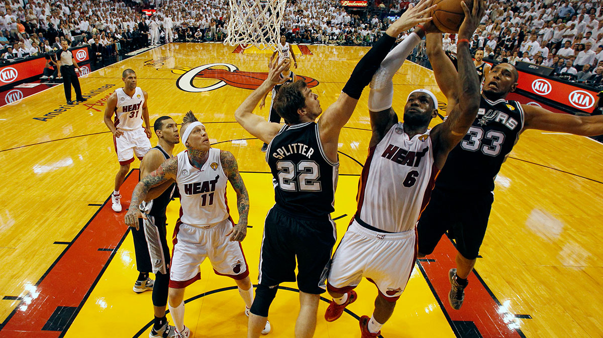 Miami Heat small forward LeBron James (6) shoots against San Antonio Spurs center Tiago Splitter (22) and center Boris Diaw (33) during the first quarter of game six in the 2013 NBA Finals at American Airlines Arena.
