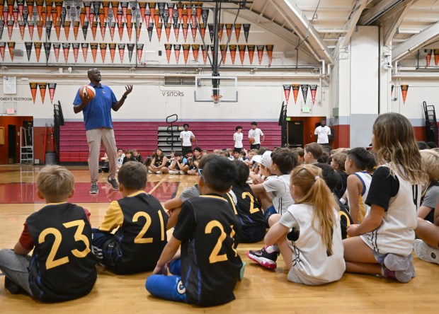 Former Warriors player Adonal Foyle speaks to kids during their...